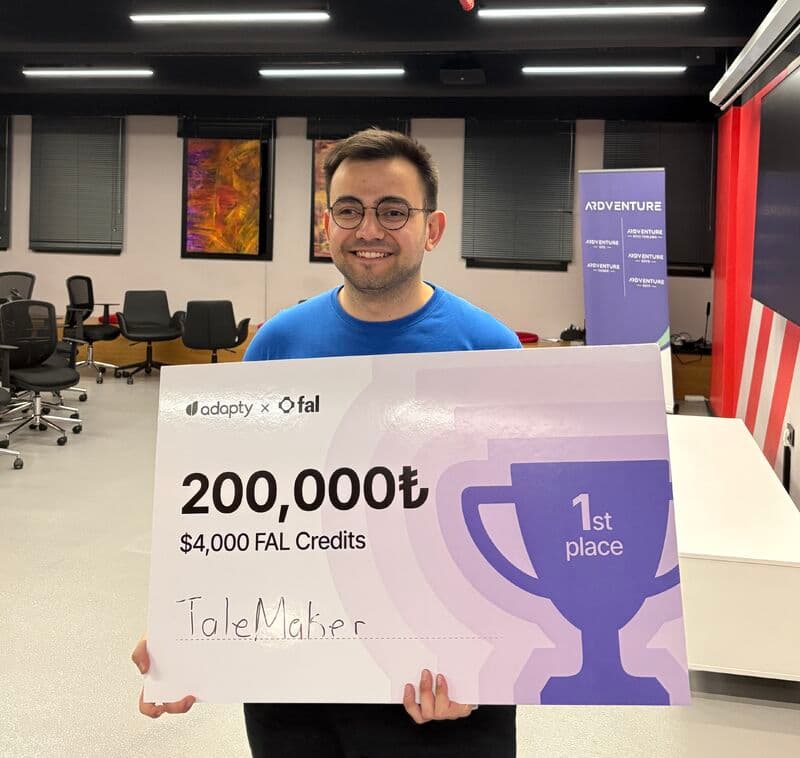 Mehmetcan Bozkuş holding the fal and Adapty first-place prize board